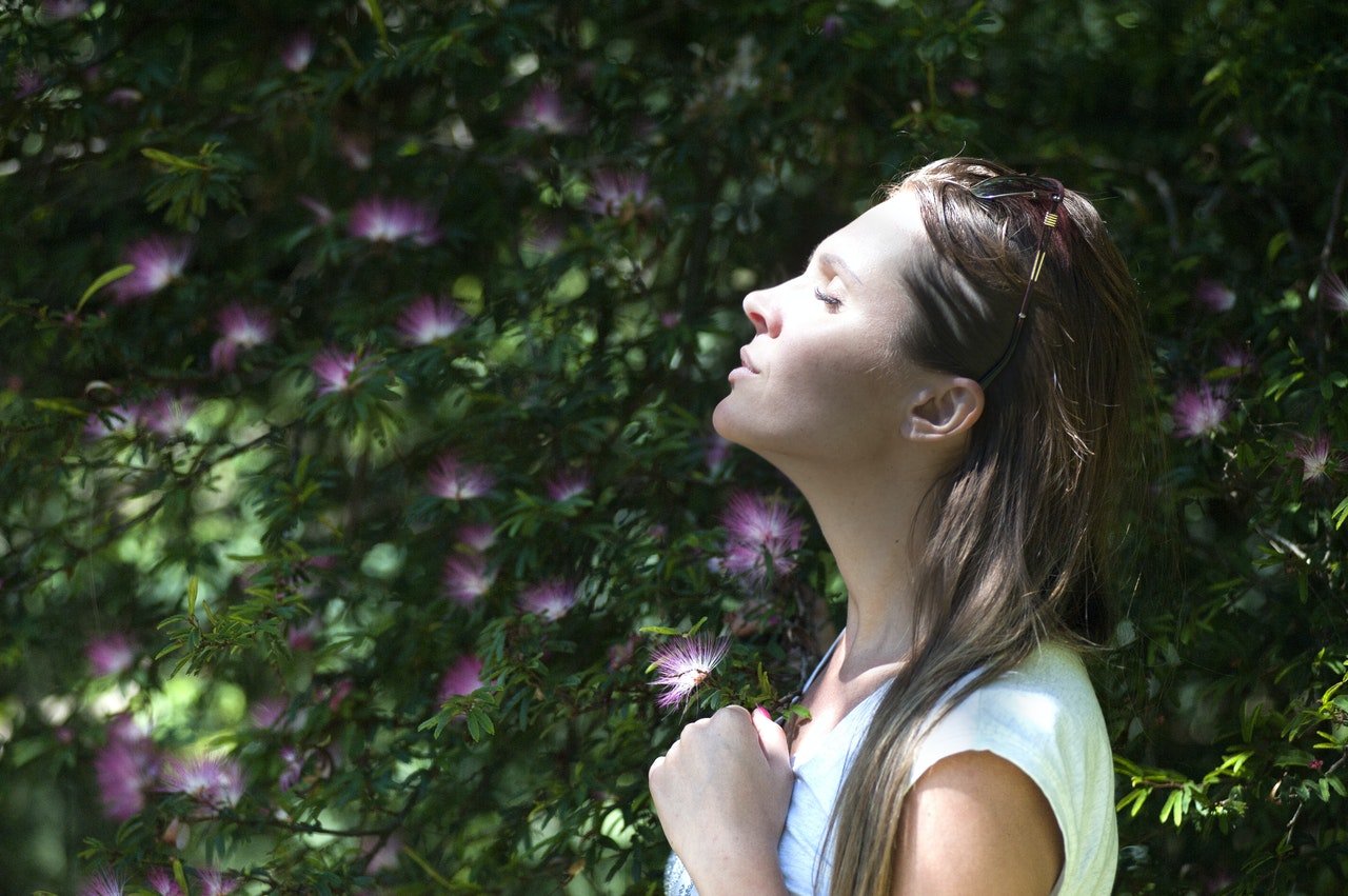 Woman taking a deep, calm breath with eyes closed