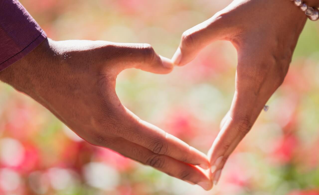 Two hands connecting to make a heart