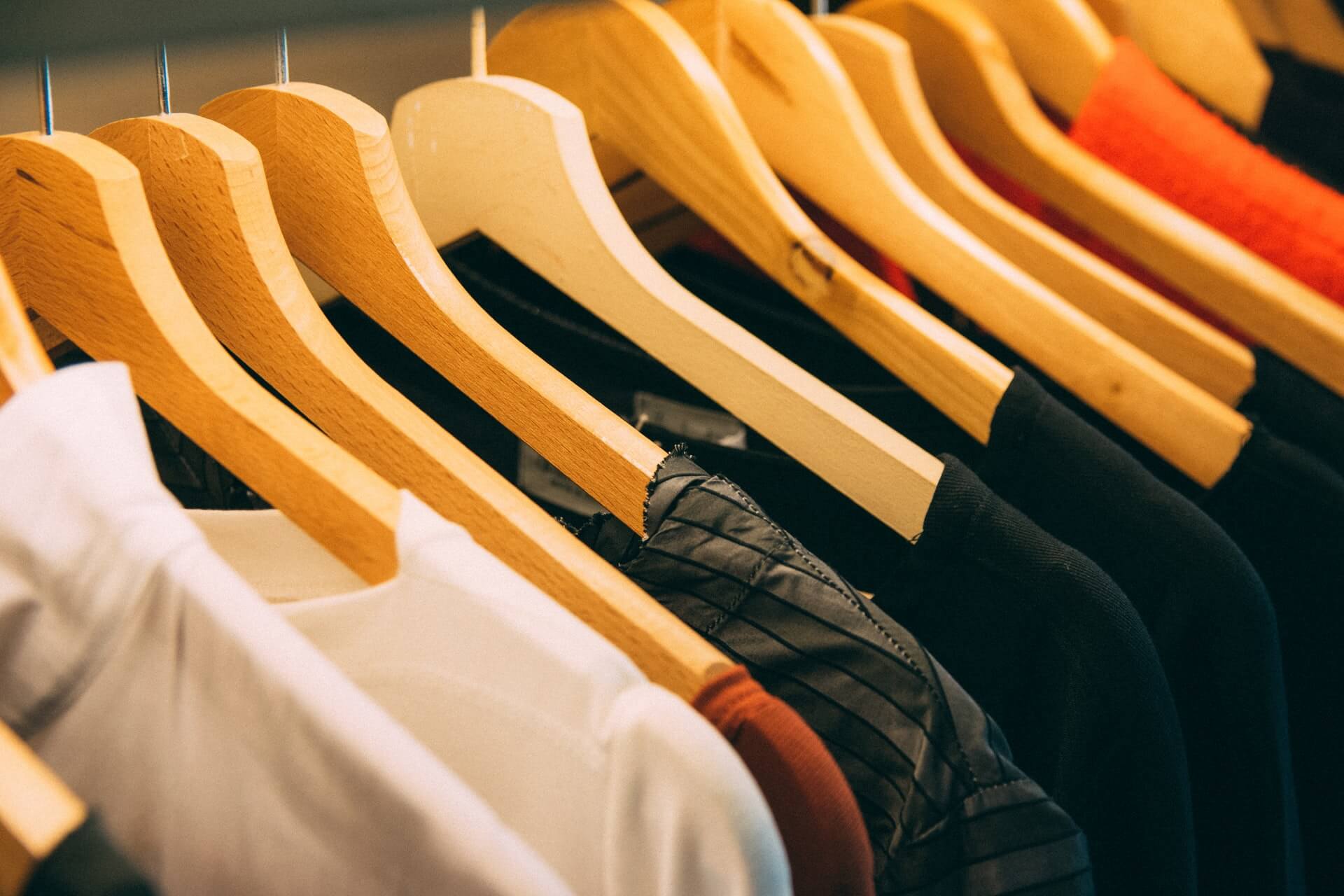 Close-up of wooden hangers with shirts hanging on them