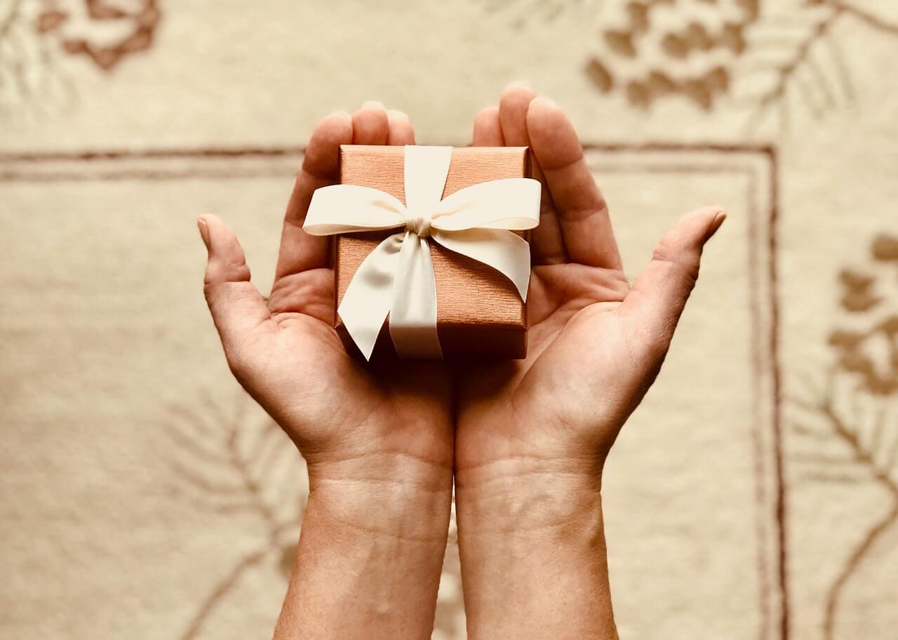 Tiny space saving gift box held in hands